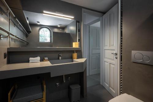 a bathroom with a sink and a mirror at Paleokastritsa Red Gate Flat in Paleokastritsa