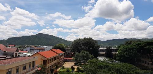 a city with buildings and a mountain in the background at Khách sạn Le Royal in Lien Nghiia
