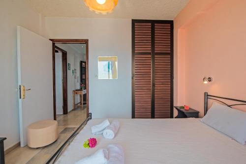 a bedroom with a bed with towels on it at Andromaches apartment sea view in Achílleion