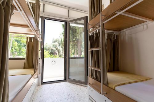 a room with bunk beds and a window at BE BOLD HOSTEL in Antalya