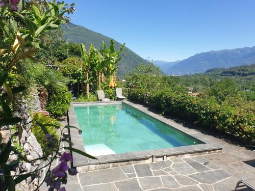 a swimming pool with mountains in the background at Casa Aries & Studio Aurora, Cavigliano in Cavigliano