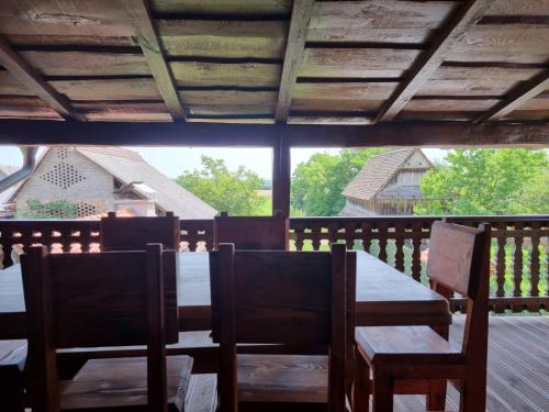 a table and chairs on the porch of a house at Oak Holiday House Nature in Krapje