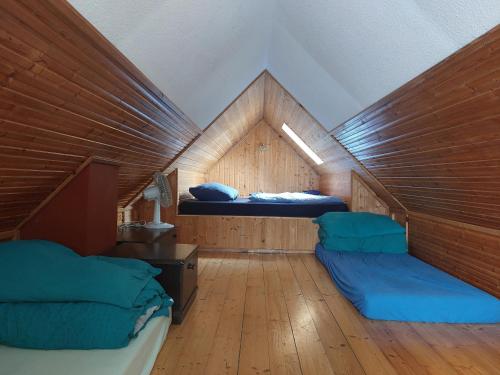 a small room with two beds in a attic at apartmán v areálu Hospoda u Dračice in Suchdol nad Lužnicí