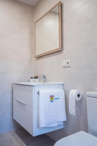 a bathroom with a white sink and a mirror at Beche EcoCamp in Santa Eulalia