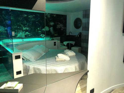 a room with a bed with a glass wall at Luxury Spa Suite Superior Assisi in Assisi