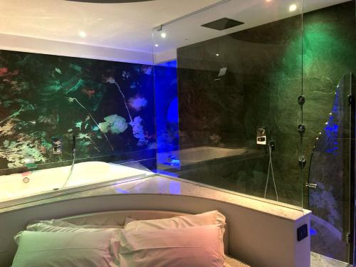 a bedroom with an aquarium and a bed and a tub at Assisi Luxury SPA Suite Superior in Assisi