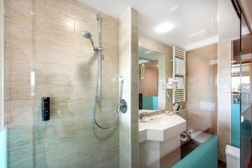 a bathroom with a shower and a sink at Diehls Hotel in Koblenz