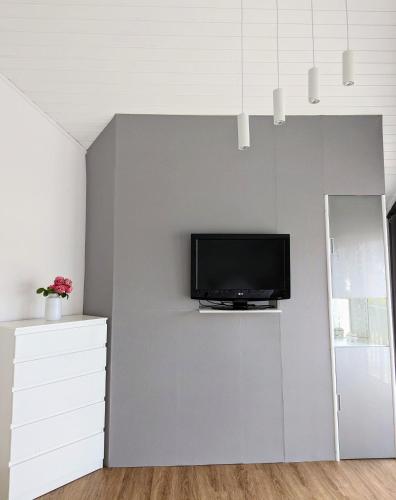 a living room with a tv on a wall at Rheinquartier Küssaberg Rheinheim in Küssaberg