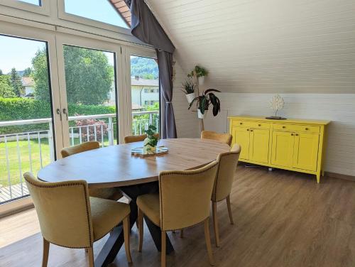 a dining room with a wooden table and chairs at Rheinquartier Küssaberg Rheinheim in Küssaberg