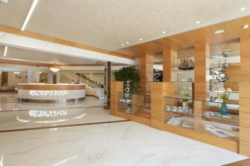 a lobby of a store with glass shelves at Hotel Golden Dune in Sunny Beach