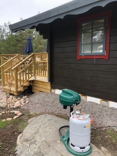 a fire hydrant in front of a house at Timber cottages with jacuzzi and sauna near lake Vänern in Karlstad