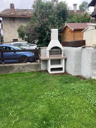 a chair sitting in a yard next to a fence at Senin House in Aosta