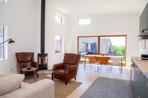 a living room with a couch and chairs and a table at Rösholmens Havsboende in Kungshamn
