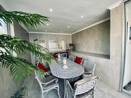 a dining room with a table and chairs at Sea View Penthouse in Ballito