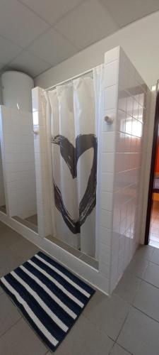 a bathroom with a urinal with a painting on the wall at Pláž Výtoň in Přední Výtoň