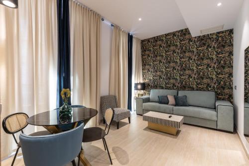 a living room with a couch and a table at BiBo Suites San Agustín in Granada