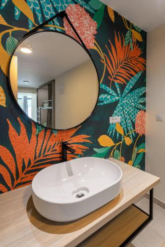 a bathroom with a white sink and a mirror at Hostel Villa Skansi in Hvar