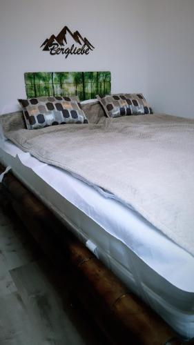 a large bed sitting in a room with at Grüne Glocke in Altenau