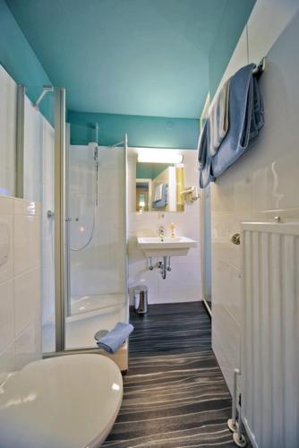 a bathroom with a shower and a toilet and a sink at Best Western Hotel Würzburg-Süd in Würzburg