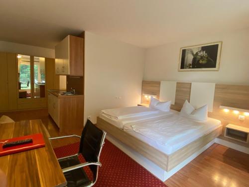 Schlafzimmer mit einem Bett, einem Schreibtisch und einem Tisch in der Unterkunft Central Hotel-Apart München in München