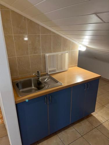 a kitchen with a sink and a counter top at Apartments Hanka in Njivice