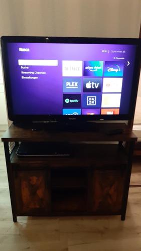 a flat screen tv sitting on top of a wooden stand at Grüne Glocke in Altenau