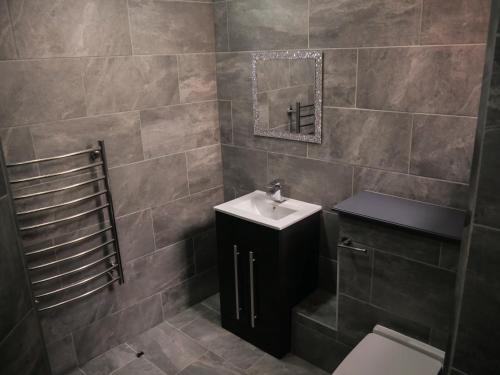 a bathroom with a sink and a toilet at New Oxford House Apartments By Happy Days in Liverpool
