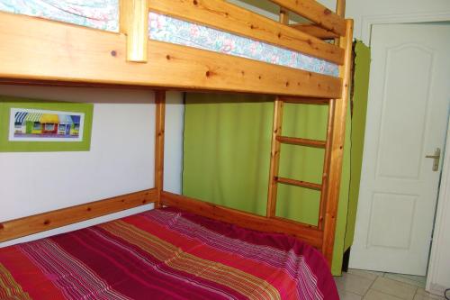 1 dormitorio con litera y escalera en Appartement d'une chambre avec piscine partagee et jardin clos a Montmartin sur Mer a 2 km de la plage en Montmartin-sur-Mer