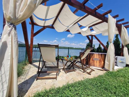 a patio with a table and chairs under a canopy at San na vodi in Smederevo