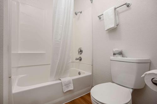 a white bathroom with a toilet and a shower at Motel 6-Temecula, CA - Historic Old Town in Temecula