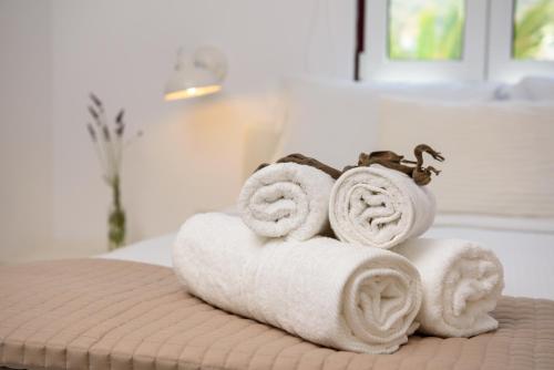 a pile of towels sitting on top of a bed at Villa Katapoliani No.3 in Katapola