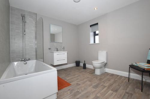 a white bathroom with a tub and a toilet at Homestead Hillsborough in Hillsborough