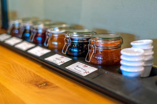 a group of jars of honey sitting on a table at Diehls Hotel in Koblenz