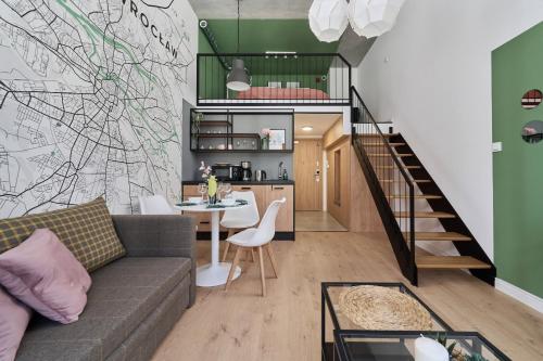 a living room with a couch and a table at Airport Studio Zarembowicza by Renters in Wrocław