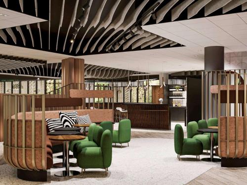 a rendering of a lobby with green chairs and tables at Novotel Poitiers Site du Futuroscope in Chasseneuil-du-Poitou
