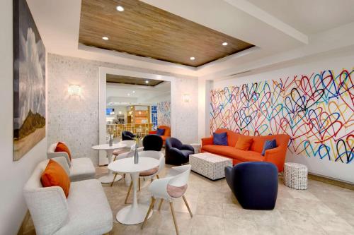 a living room with a colorful mural on the wall at MB Hotel, Trademark Collection by Wyndham in Miami Beach