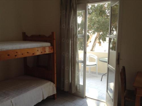 a bedroom with two bunk beds and a balcony at Rooms to let Katerina & John's in Perissa