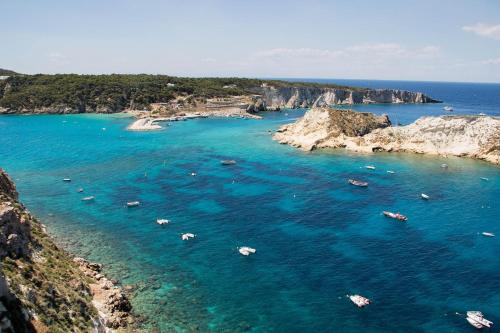 a group of boats in the water near some rocks at Centro Turistico San Nicola in Peschici