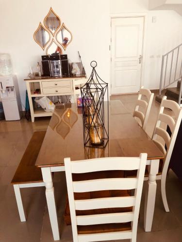 a dining room with a wooden table and chairs at Lovely penthouse 4- bedroom directly on the lagoon in El Alamein