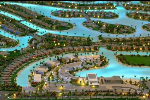 an aerial view of a resort with blue water at Lovely penthouse 4- bedroom directly on the lagoon in El Alamein