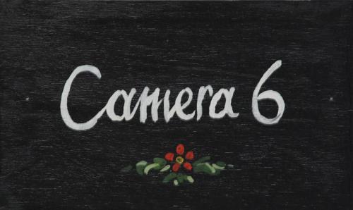 a sign with the word cambria and a flower at il Palazzo Rooms & Suites in Nafplio