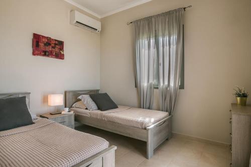 Кровать или кровати в номере Villa Elaia