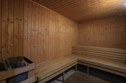a sauna with wooden walls and a wooden bench at Eleni Holiday Resort in Paphos City