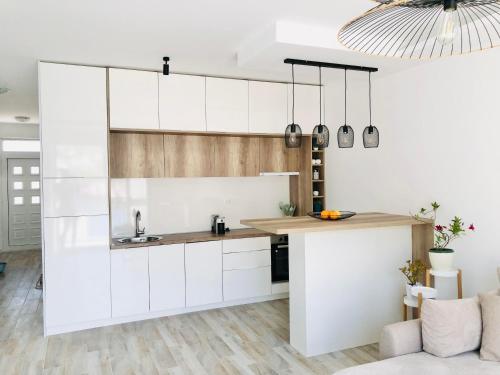 a kitchen with white cabinets and a counter at Apartment Seaside in Pržno