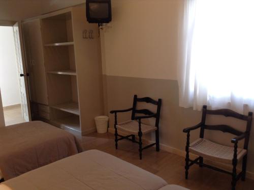 Ένα ή περισσότερα κρεβάτια σε δωμάτιο στο Kamari Beach Hotel 