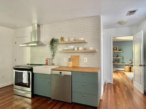 a kitchen with blue cabinets and a counter top at Brand New, Cozy, Modern, One-bedroom Apartment in Falls Church