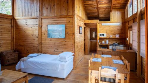 a bedroom with a bed and a table and chairs at Bushman Valley in Prince Albert