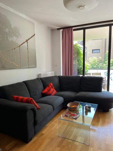 a living room with a couch and a glass table at Apartament Lux 2 camere Nordului in Bucharest