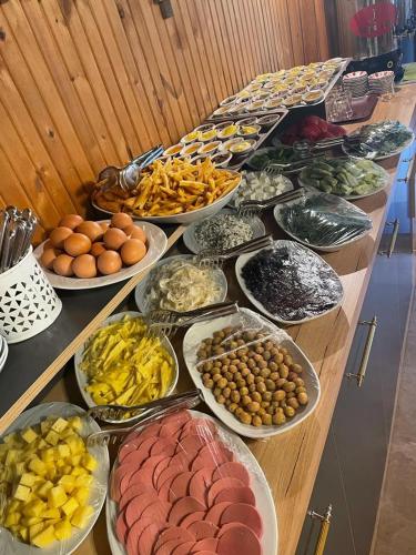 a table with many plates of different types of food at Ayder Vesile Otel in Ayder Yaylasi