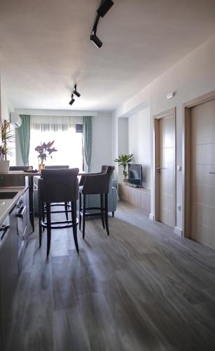 a large living room with a table and chairs at Allure Apartments in Ulcinj